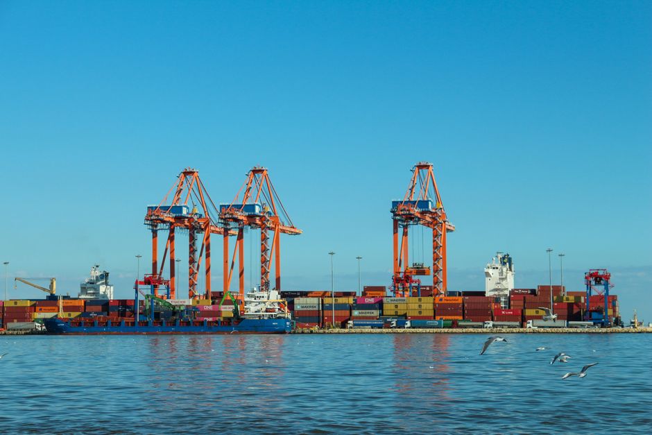 A feeder vessel at a transshipment hub.