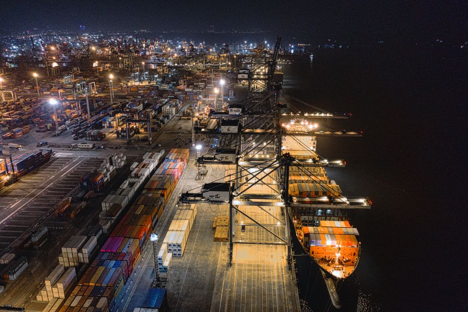 Customs officers inspecting a container during a dangerous-goods verification at a Chinese port.